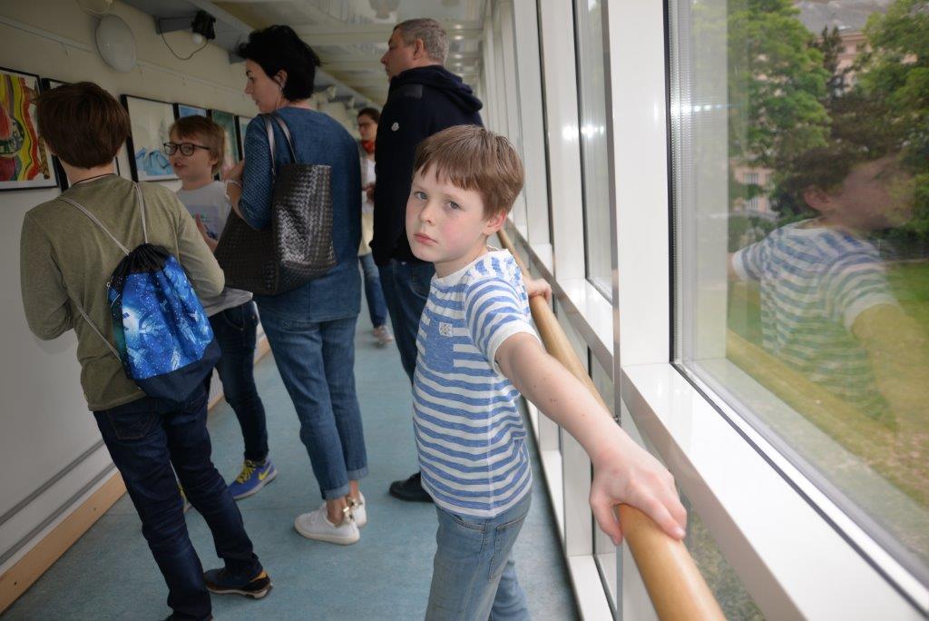 Schüler und ihre Eltern schauen die Bilder in der Galerie an